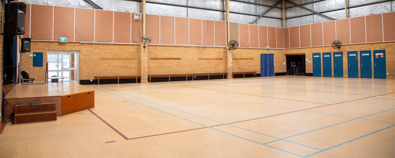 The stage area has a sound system with two speakers