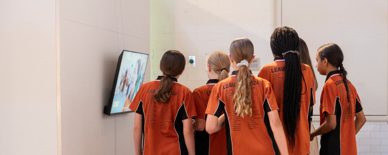 Students enjoying the exhibition of their work, In the Beginning, photograph by Hugh Sando