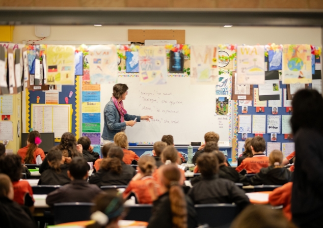 Author Deb Fitzpatrick mentoring young writers in the classroom.