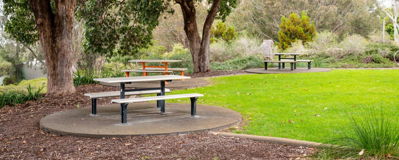 There are picnic tables in the scenic area outside the hall 