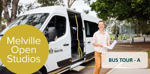 Smiling man standing in front of a city of melville van