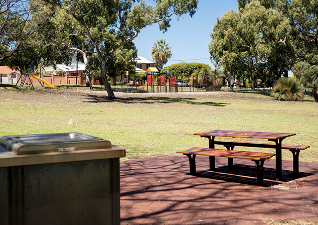 Picnic area with bench and children's playground