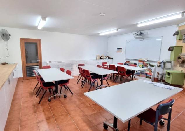 Small room for workshops set up with four trestle tables