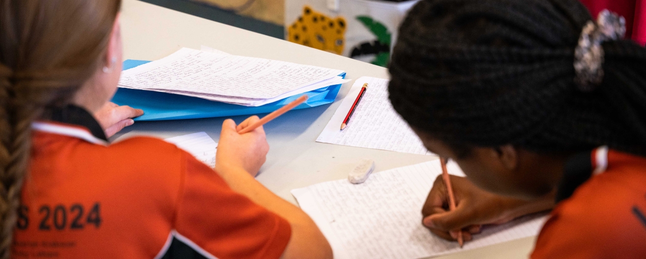 Students during a mentoring session with a published author, preparing their stories for the book, photograph by Cole Baxter