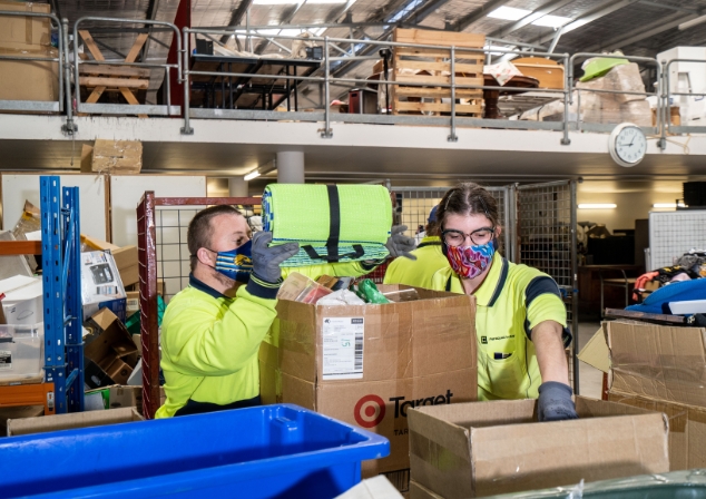 Image of two people sorting donated items