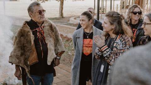 Image of a smoking ceremony and community members