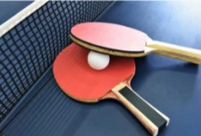 Two table tennis paddles and a table tennis ball
