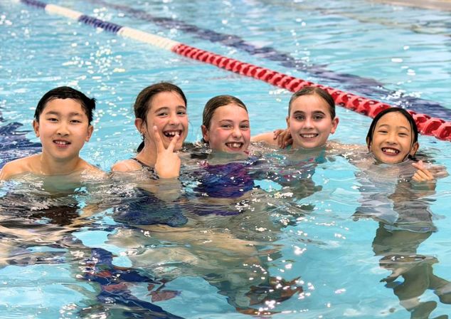 Young adults smiling in the pool