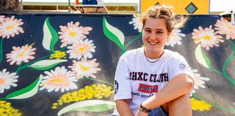 Picture of you young person in front of wall art