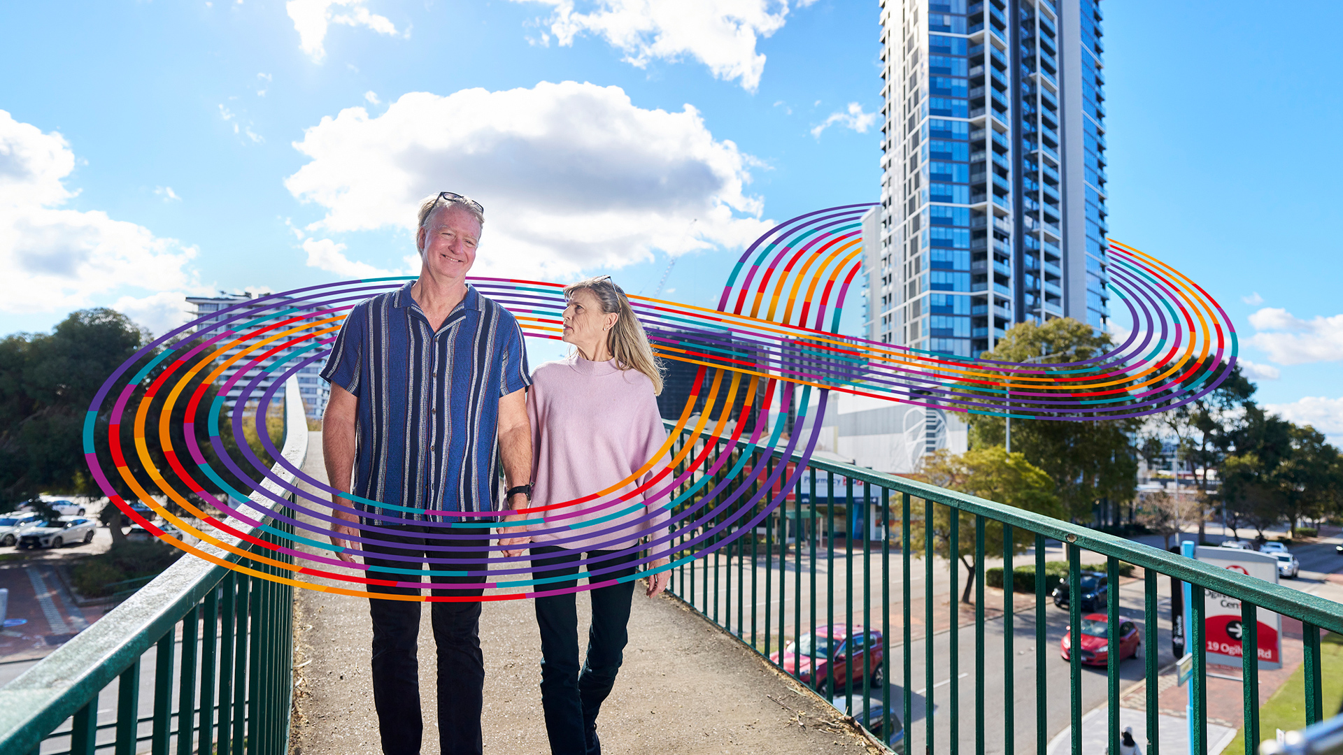 Older couple walking on a pedestrian bridge