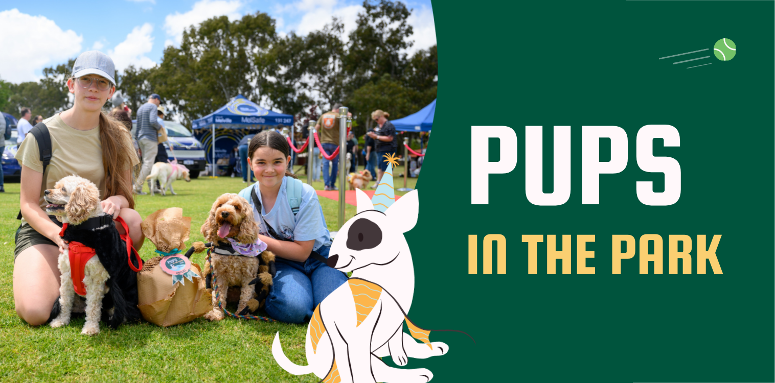 Two children pose with two dogs at a community event.