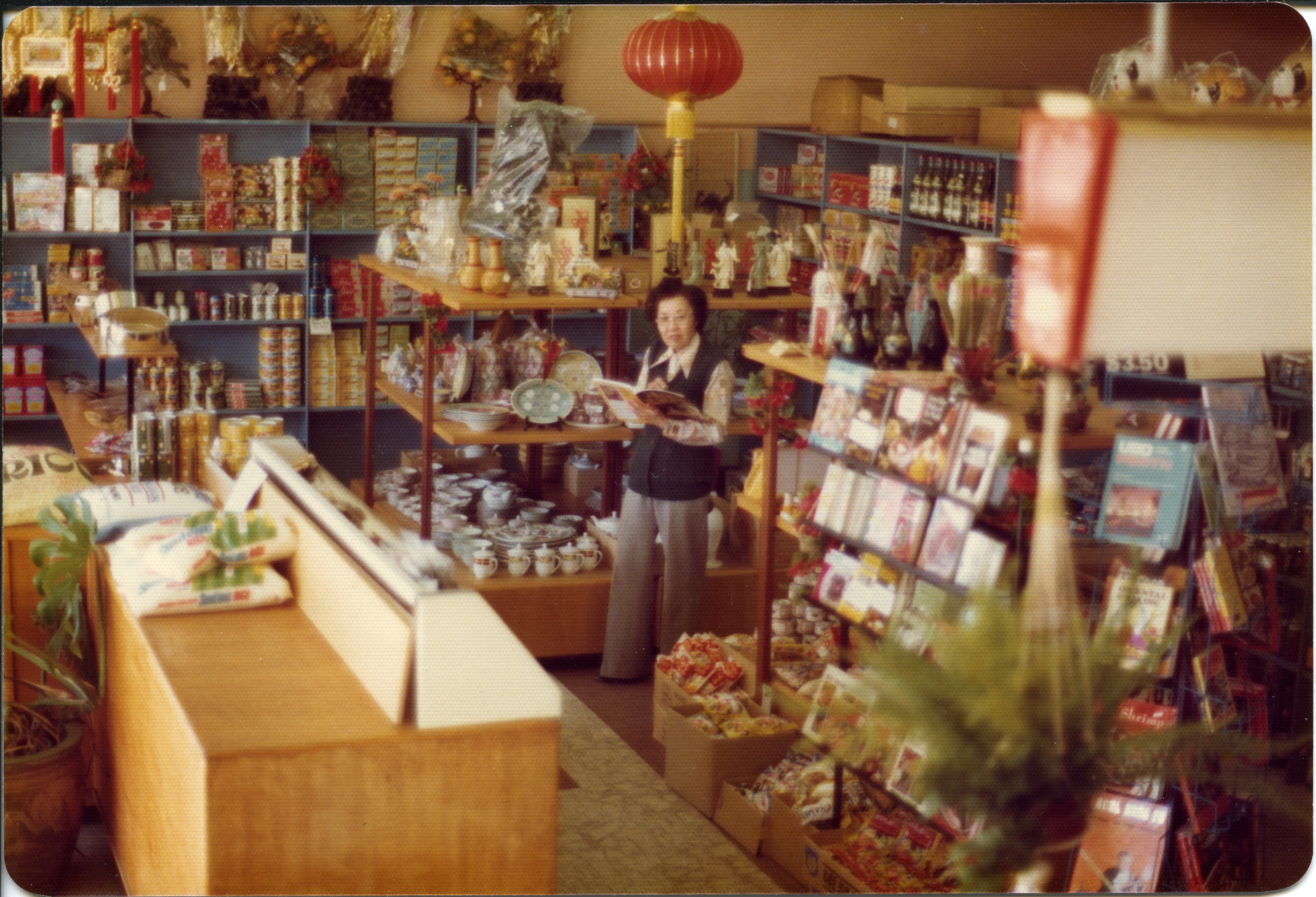 Photograph of Win Fong inside Hop Hing Chinese Food and Craft Store on Canning Highway in Mount Pleasant in 1977. 