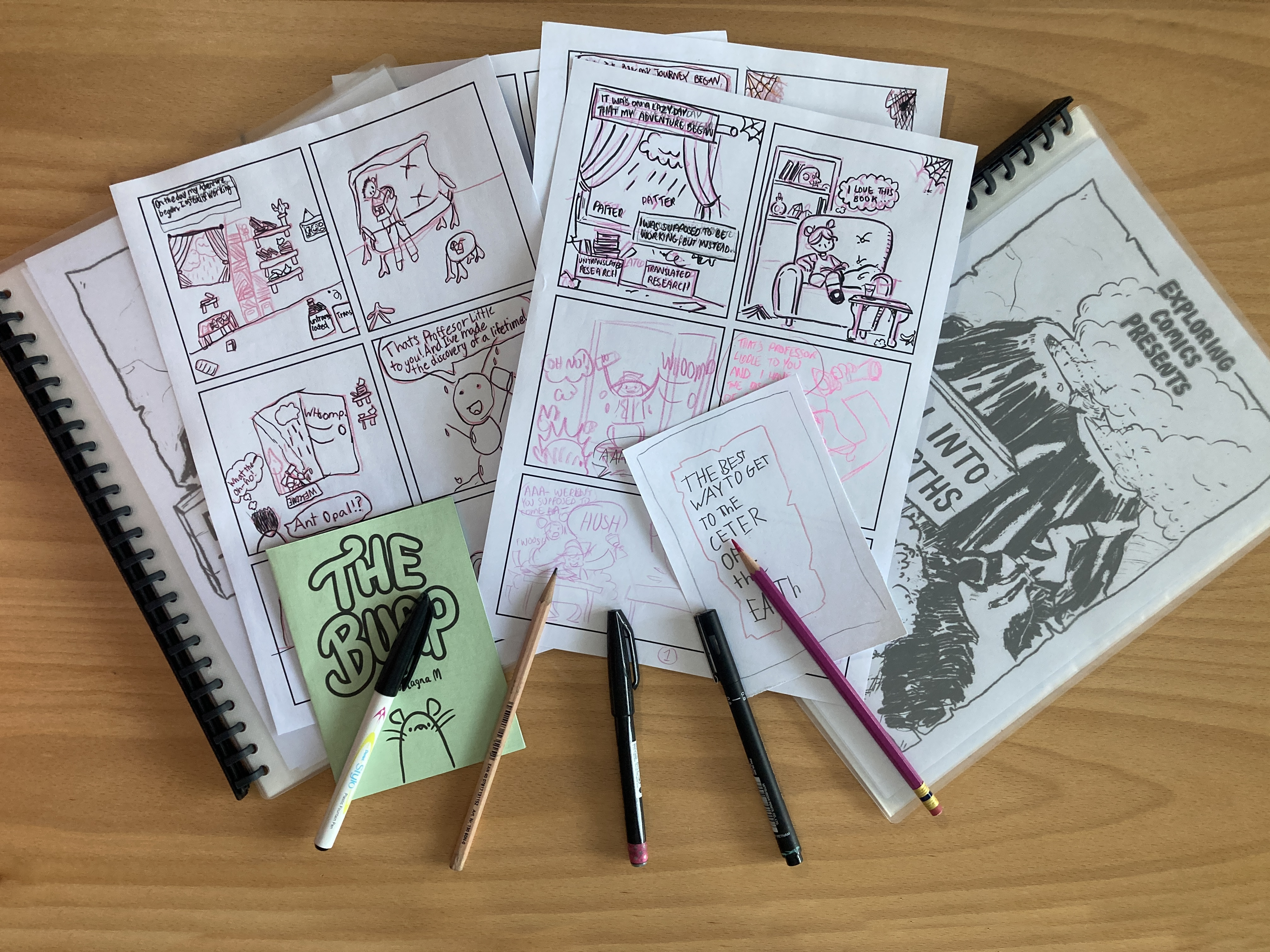 A book of comics with pens.