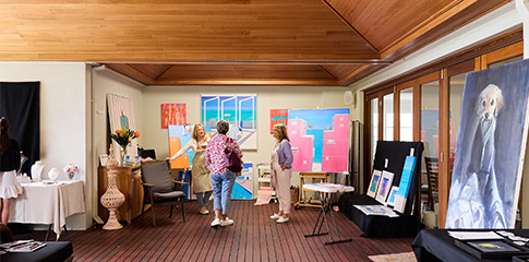 people in an art studio observing the art