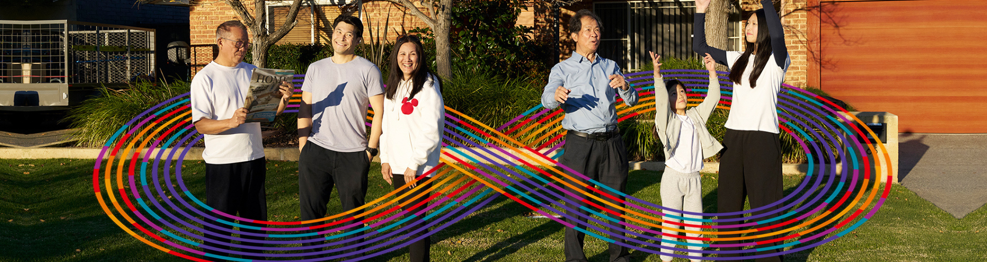 A family standing out the front of their home with an infinity symbol around them.