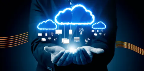 A pair of hands holds a techy cloud image featuring network and computing icons.