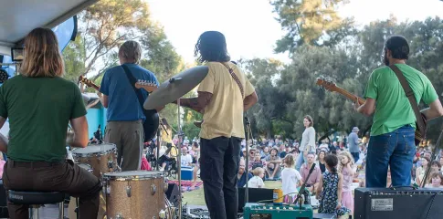Four band members performing at the Melville Summer Music Series