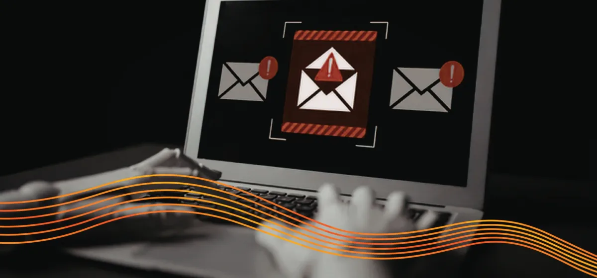 An email alert appears on a laptop screen