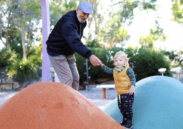 Grandparent with grandchild in playground