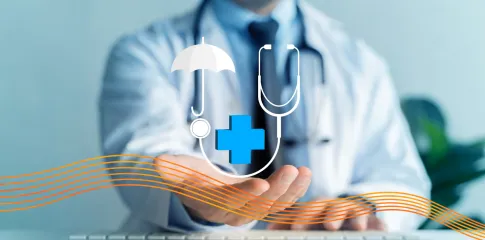A person dressed in a lab coat and wearing a stethoscope reaches out.