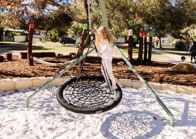 photo of child playing on swing at Bicton Substation playground