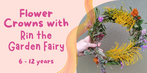 An image of a hand holding up a crown of different flowers and leaves in different shapes and sizes that have been weaved together.