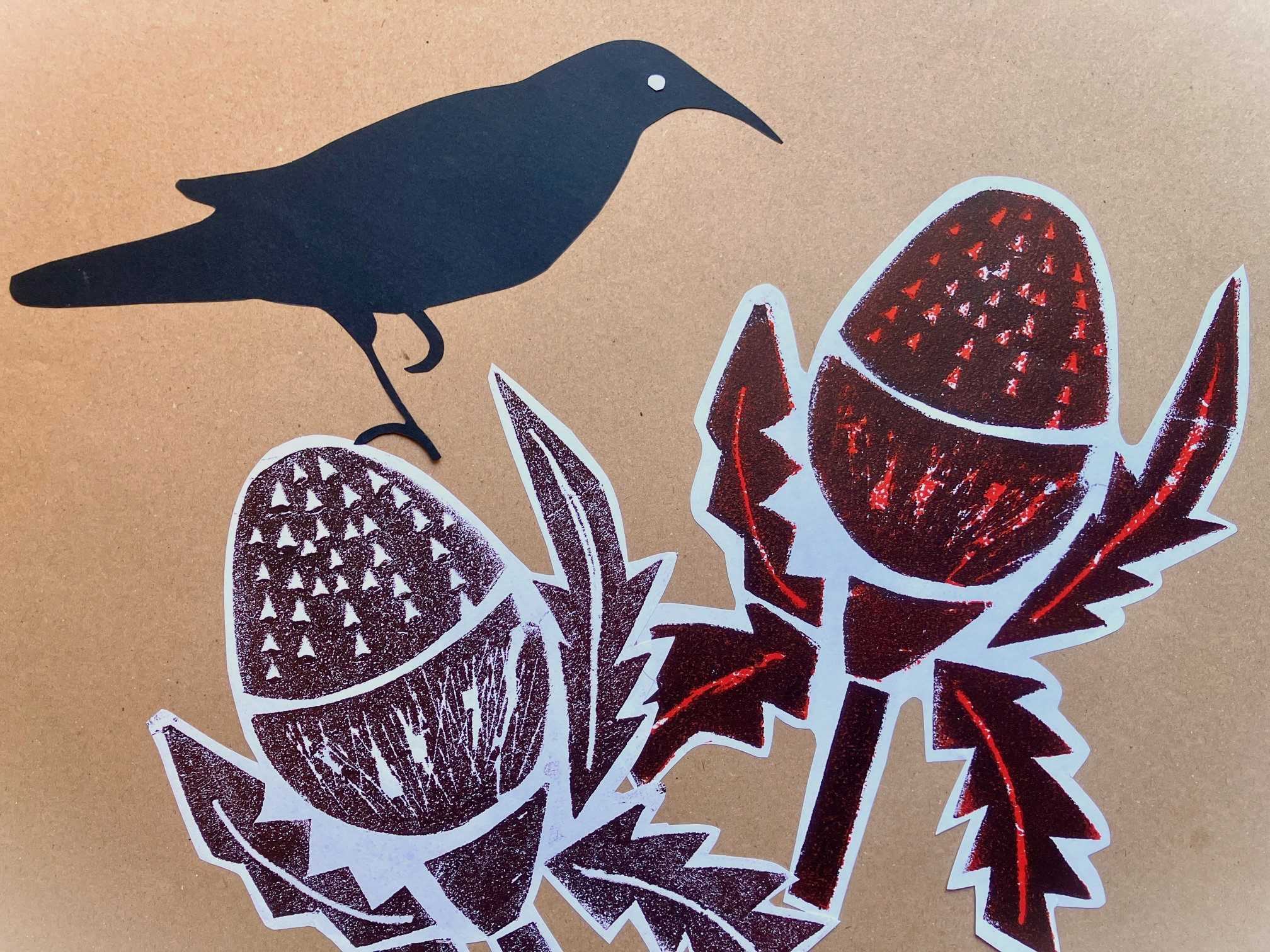 A print of a crow sitting on some brown native flowers.